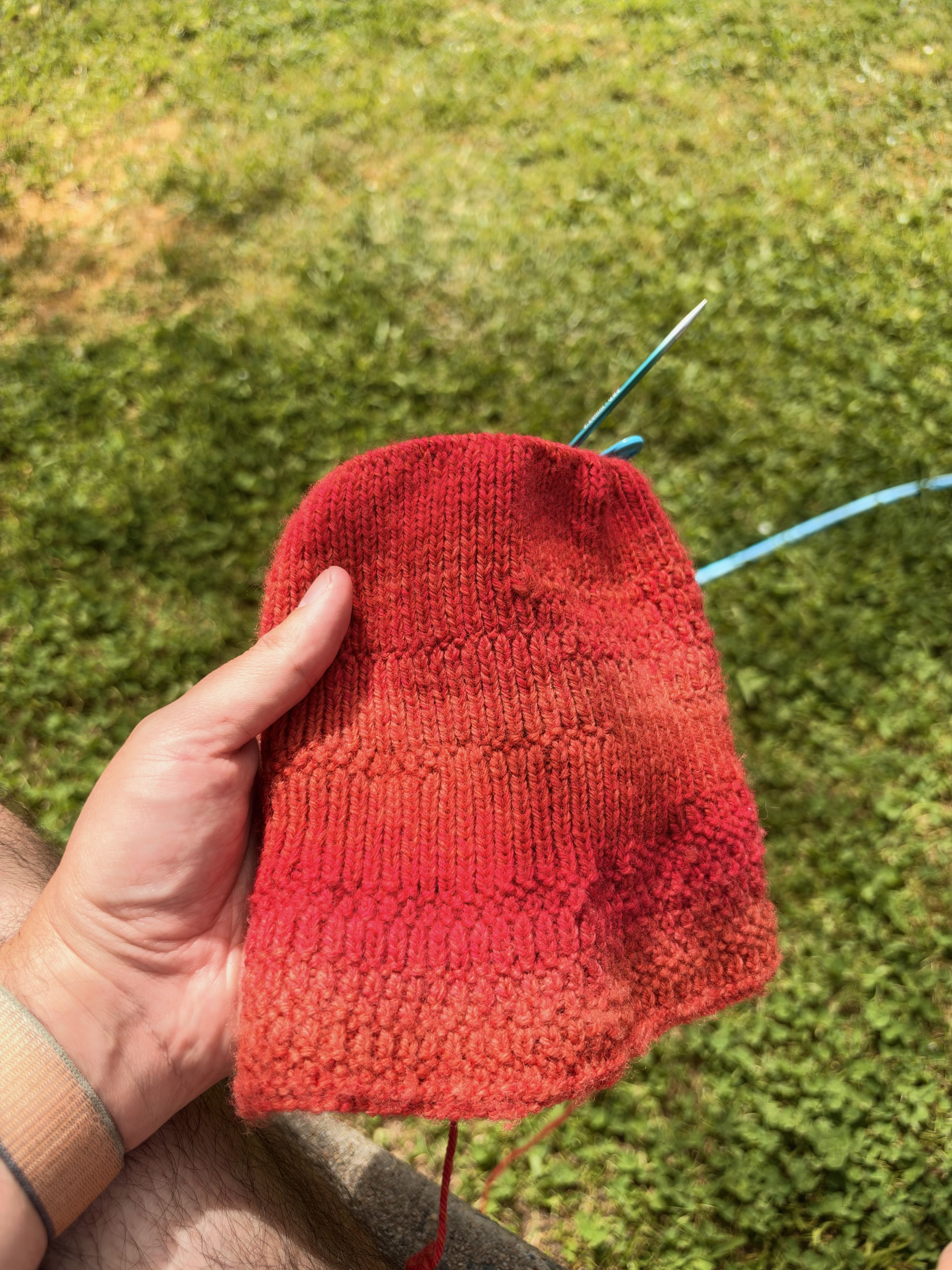 A work in progress of a red wool beanie